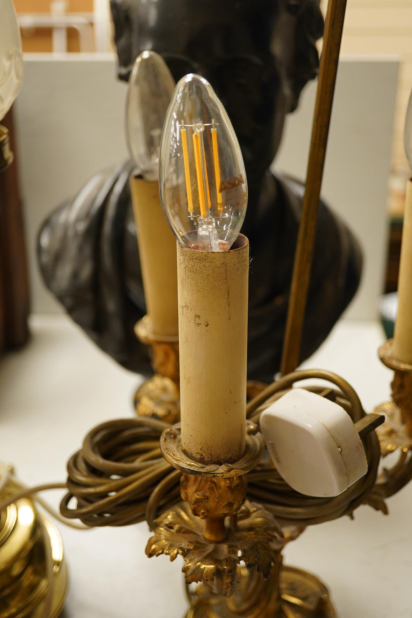 A plaster library bust possibly Keats?, an ormolu three light table lamp with red tole shade, 63cm high, and a large brass candlestick lamp on lion feet. Condition - fair to good